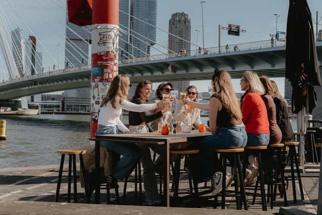Networking event at Prachtig restaurant with iconic urban backdrop for corporate engagement.
