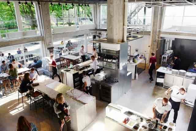 Industrial-chic restaurant with communal seating for networking events and corporate breakouts.
