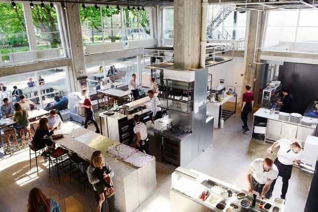 Industrial-chic restaurant with communal seating for networking events and corporate breakouts.