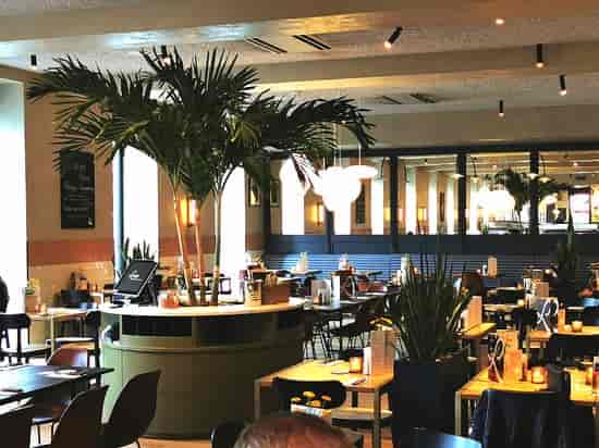 Loetje restaurant with high ceilings, ideal for professional networking mixers and corporate dinners.