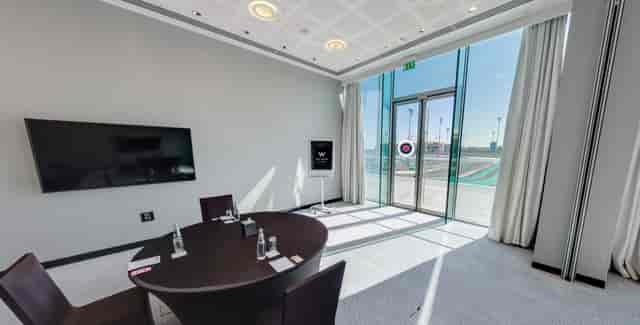 Modern meeting room at W Abu Dhabi - Yas Island with large table and natural light.