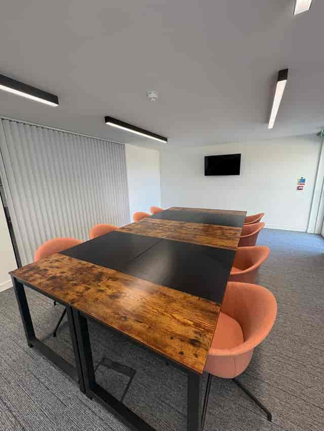 Modern Banning Street breakout room with modular table for small team meetings and planning.