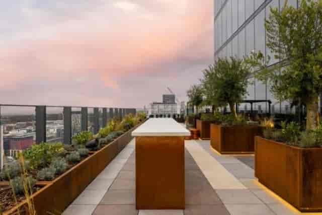 High-end rooftop terrace with integrated lighting for networking events and cocktail parties.