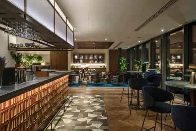 Corporate reception lounge with bar and seating for networking events.