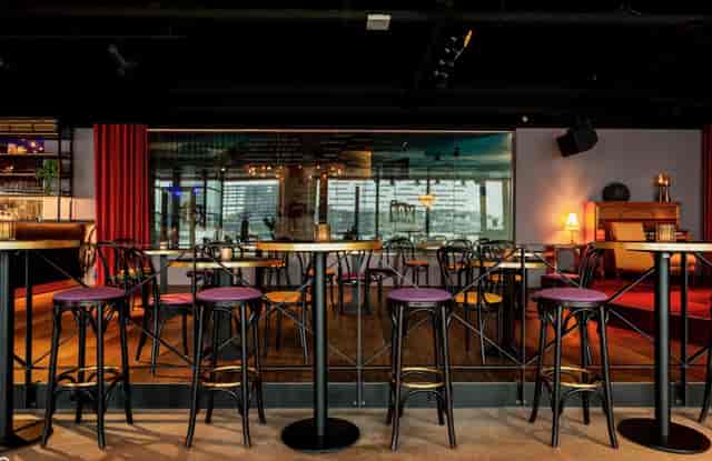 Café Dox lounge setup: high-top tables for networking receptions and cocktail hour events.