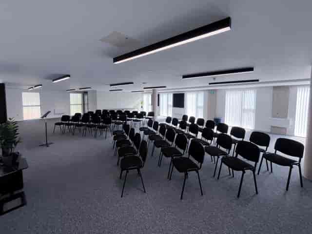 Theater-style conference room with natural light for corporate meetings and training sessions.