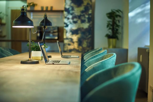 Velvet co-working breakout room with task lighting for corporate meetings and professional events.