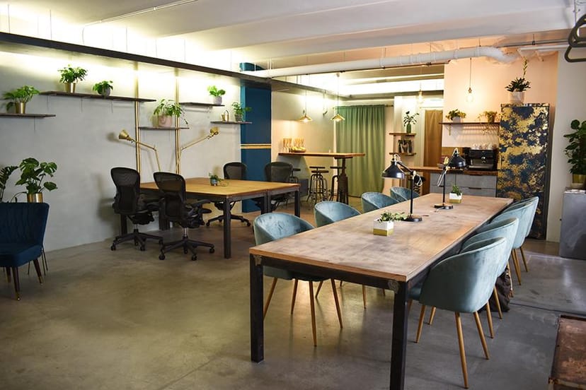 Biophilic coworking hot desk for creative team workshops and collaborative events.