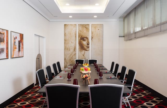 Upscale boardroom at Leonardo Hotel Munich for professional corporate meetings and executive events.