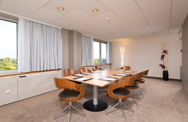 Boardroom at Leonardo Hotel Munich Arabellapark, ergonomic seating for strategy sessions or meetings.