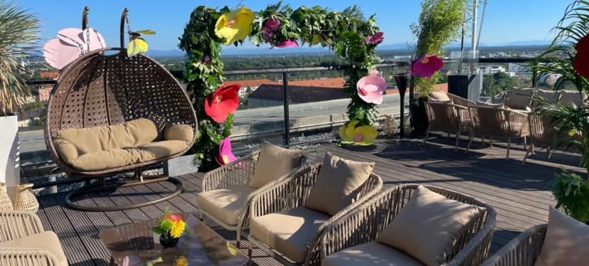 Rooftop reception with floral arch at Upside East for corporate events and brand activations.