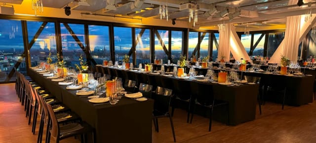 Upside East rooftop gala with sleek tables and city views for corporate events and networking.