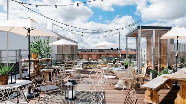 Chic rooftop terrace with bistro lighting for corporate networking and social events.