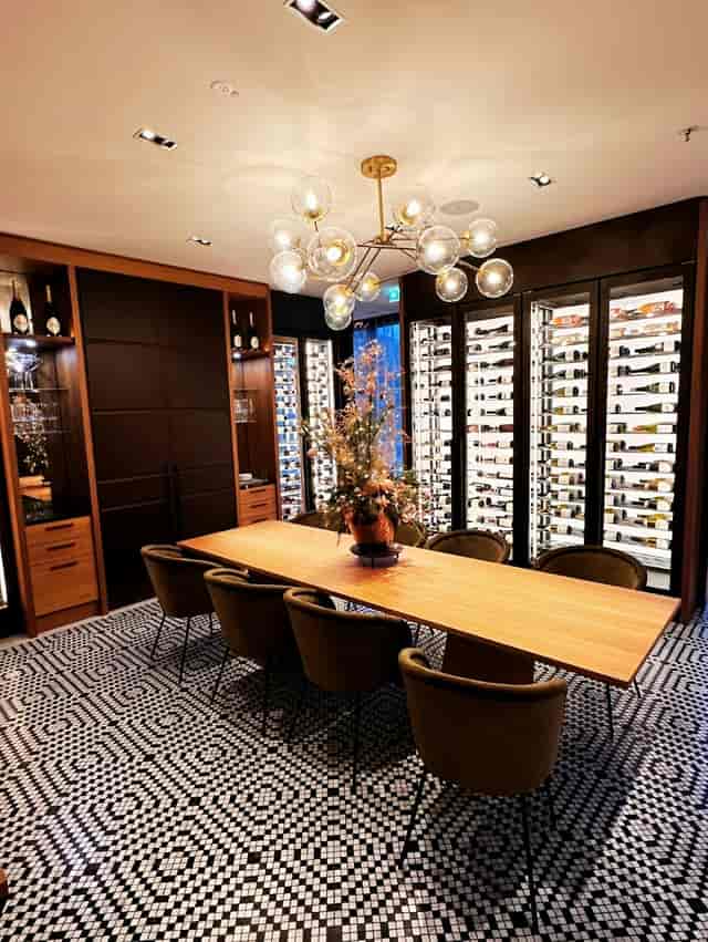 Munich Marriott Hotel private dining room with illuminated wine wall for executive board meetings.