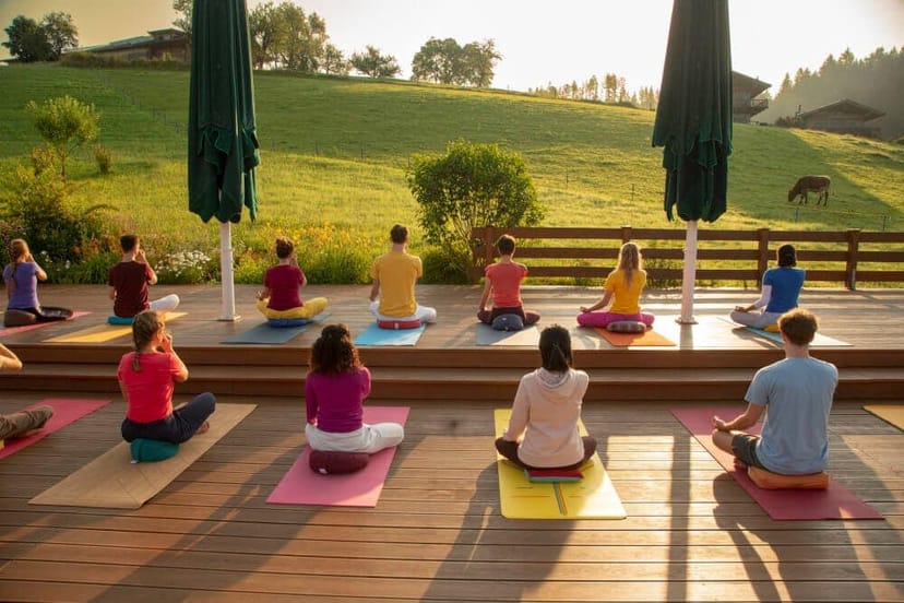 Yoga retreat at alpine Schlosspalais outdoor deck for wellness incentive travel.