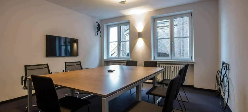 Boardroom setup at FOX LOUNGES with quirky wall art for team sync and breakout meetings.