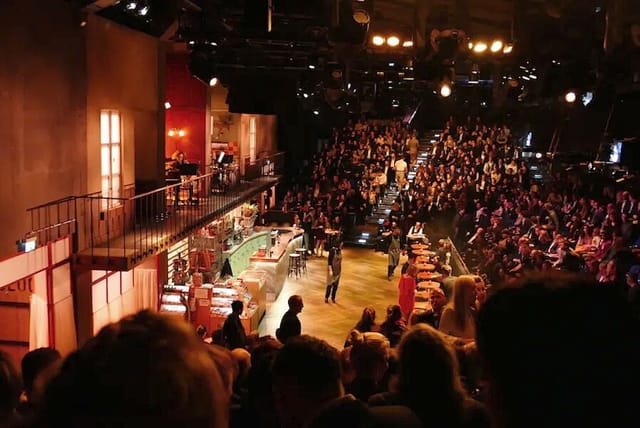WERK7 theater with tiered seating and stage for immersive event and corporate conference rental.