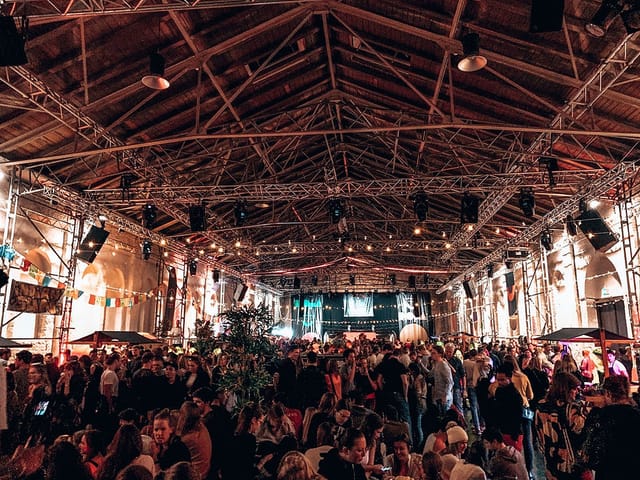 Utopia industrial function room with overhead rigging for networking events and festivals.