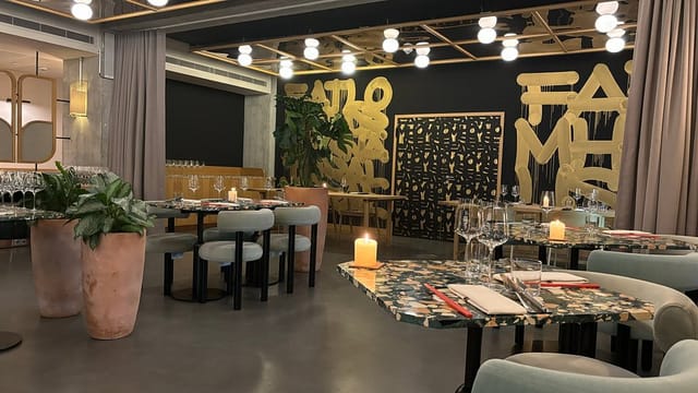 Modern restaurant dining space with terrazzo tables for upscale networking and private events.