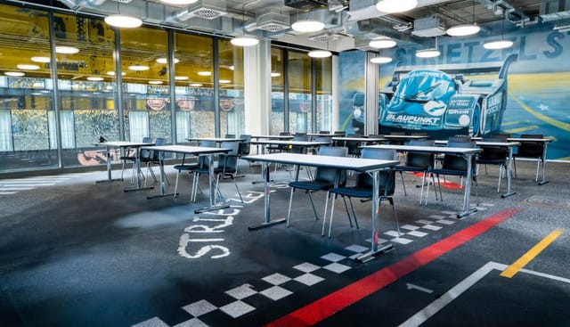 Racing-themed classroom at Motorworld München for corporate training and workshop events.