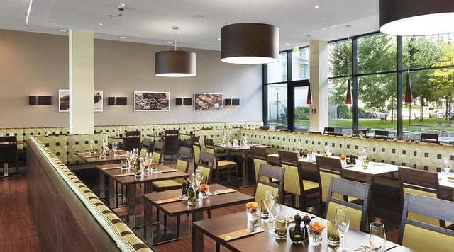 Modern meeting studio with modular tables for corporate luncheons and networking events in Munich.