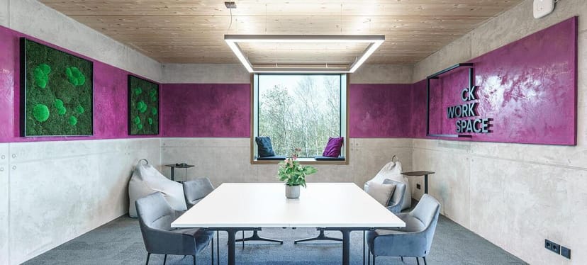 Modern team meeting room with collaborative lounge seating for corporate brainstorming and workshops.