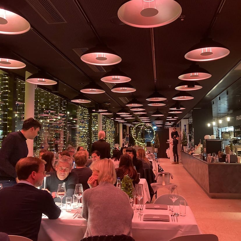 Corporate dinner at Deutsches Museum rooftop with professional table settings and festive ambiance.