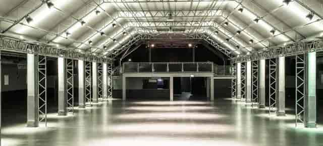 Industrial hall venue at Technikum with overhead lighting truss for corporate events and galas.