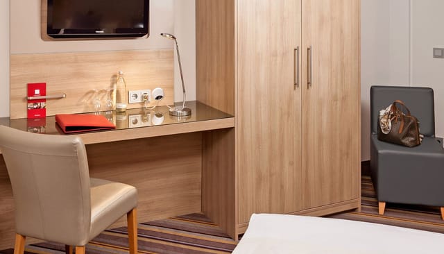 Modern hotel room workstation in Leonardo Hotel Munich City North for business travel events.