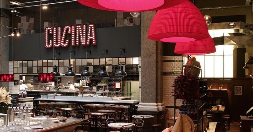 Industrial-chic restaurant suite with open kitchen for networking events and team lunches.