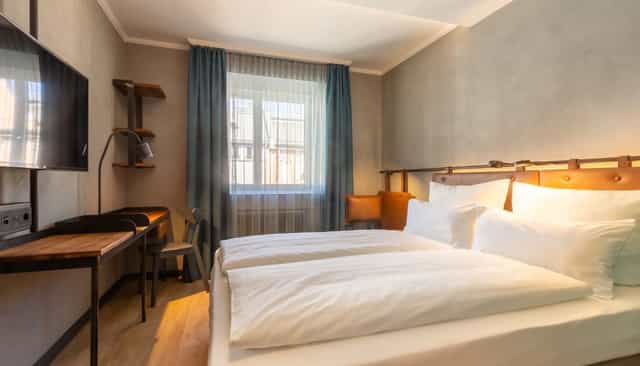 Modern hotel room with dedicated workspace, ideal for corporate travel and business accommodation.
