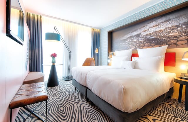 Modern NYX Hotel Munich workspace with premium bedding for upscale corporate events and conferences.