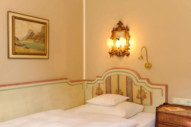 Classic suite at Hotel Splendid with dated decor, ideal for corporate event room blocks.
