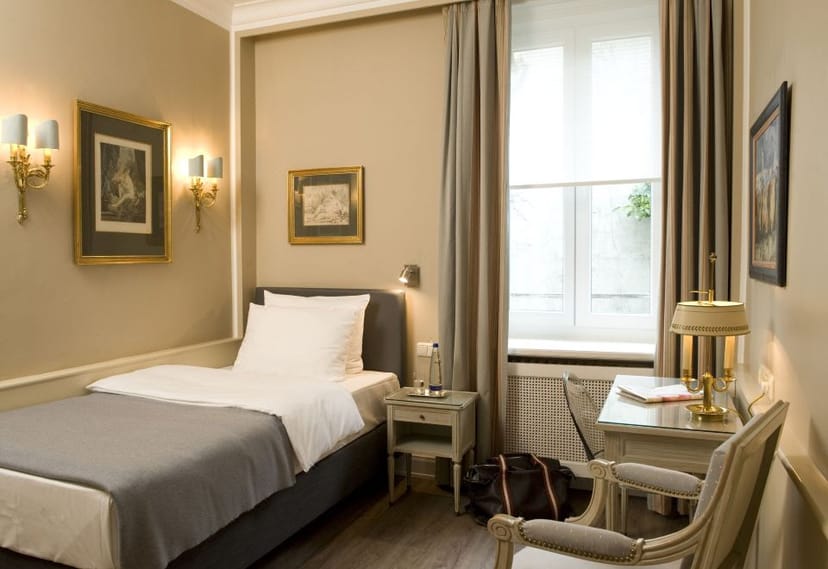 Hotel Splendid single-occupancy guest room with workspace for business travel and conferences.