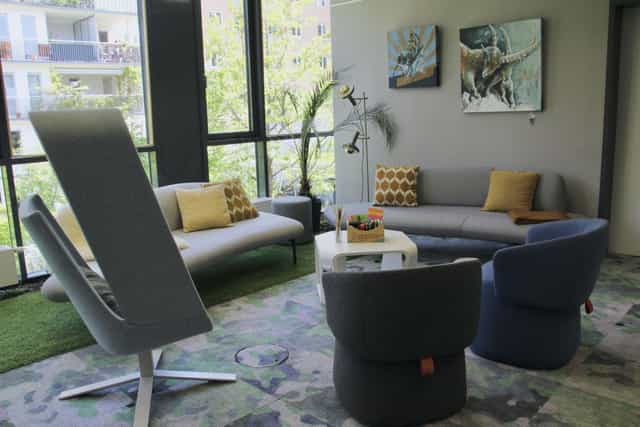 Casual breakout space with soft seating for networking and fireside chats.