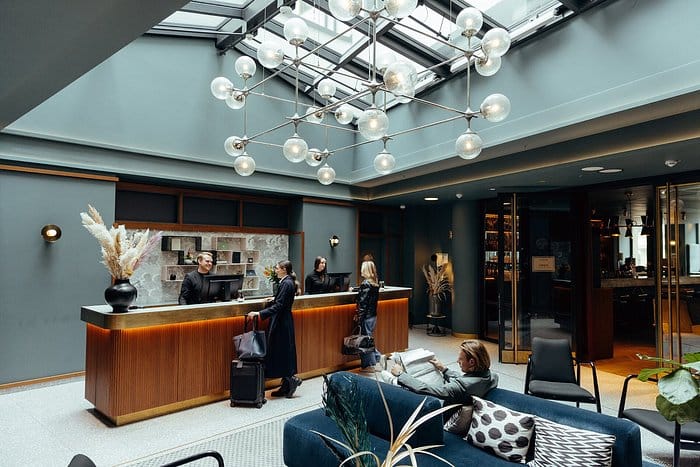 Modern hotel lobby with lounge seating for group check-in and corporate event space.