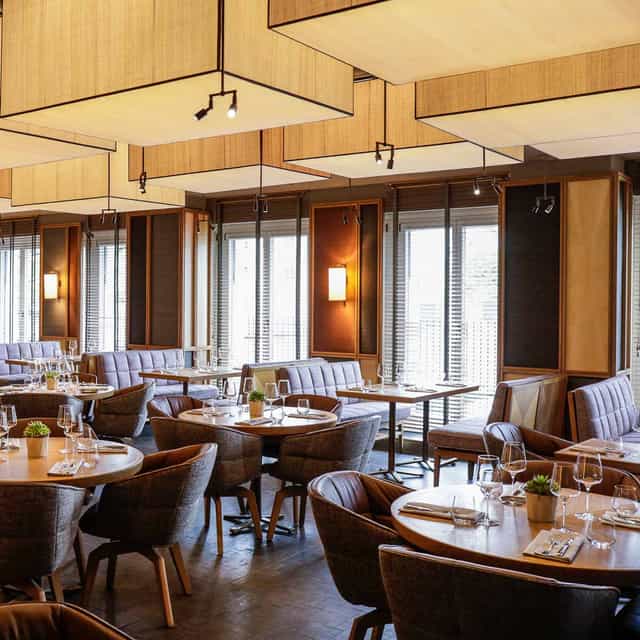 Upscale Louis Grillroom restaurant with banquette seating for corporate dinners and VIP events.