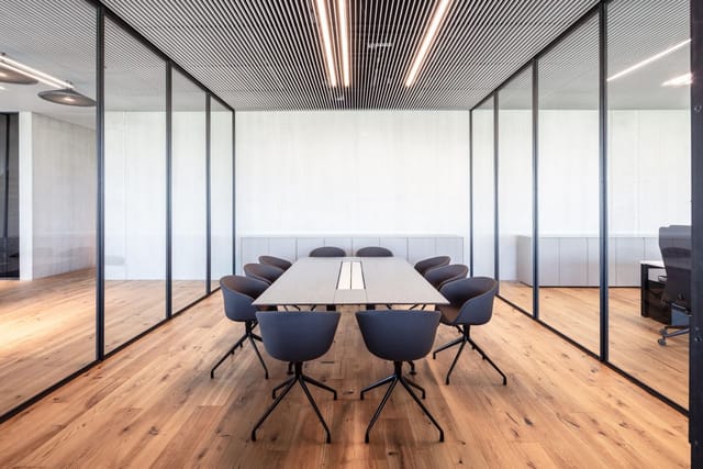 Minimalist Titan boardroom with glass walls for executive meetings and corporate strategy sessions.