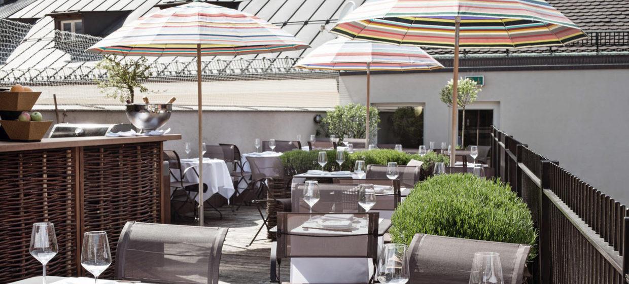 LOUIS Hotel rooftop terrace with elegant tables for an intimate networking reception or event.