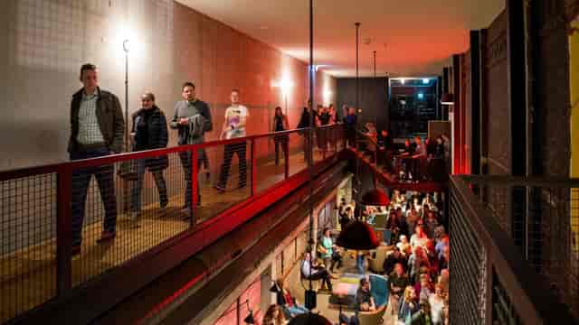 Oude Luxor Theater industrial foyer: multi-level event venue for networking and conferences.