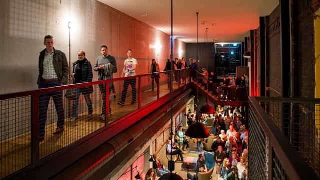 Oude Luxor Theater industrial foyer: multi-level event venue for networking and conferences.