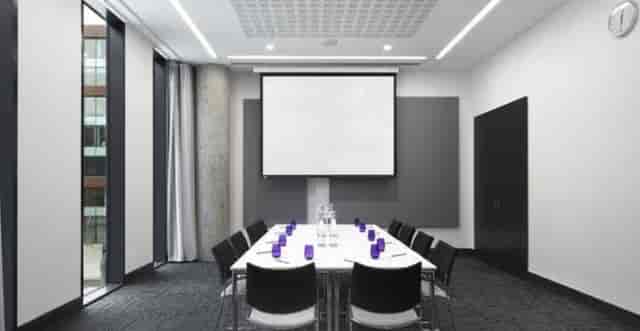 Modern meeting room in INNSIDE Manchester, ideal for presentations and professional gatherings.