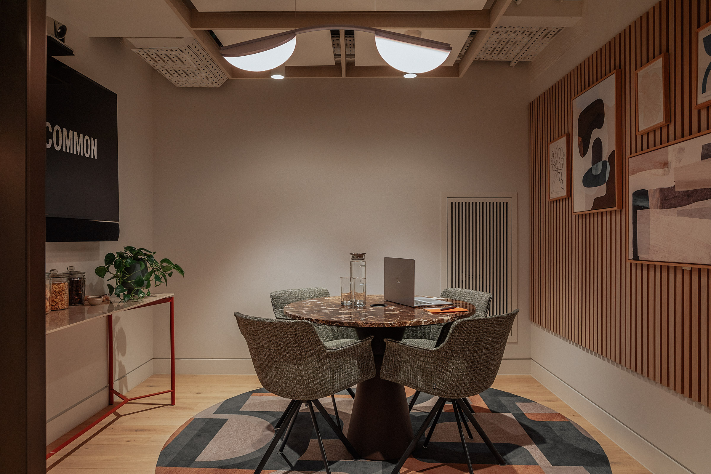 Sleek meeting room with round table, ideal for brainstorming sessions.