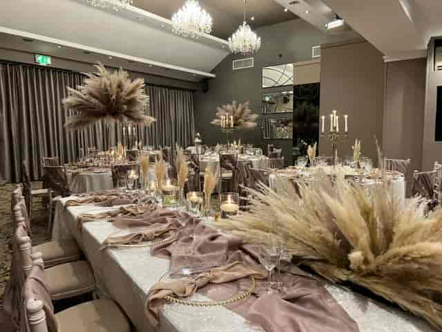 Taupe banquet setup with pampas grass at Red Hall Hotel for upscale wedding or formal gala.