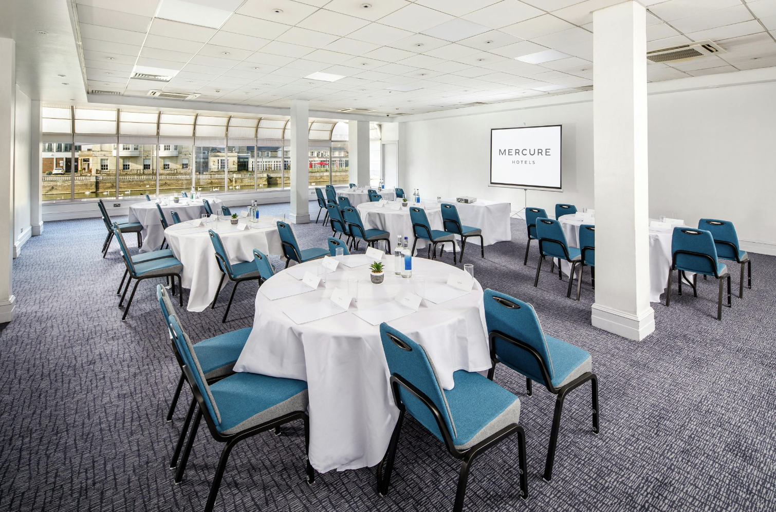 County Suite at Mercure Bedford: Cabaret-style meeting room with natural light for events.