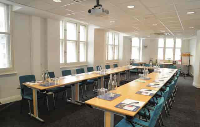 Professional training room in Broadway House, featuring a long table and projector setup.