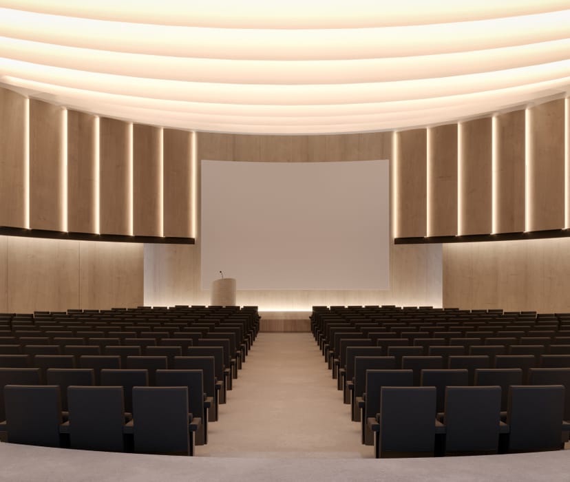 Modern Grand Hall auditorium with theater seating for corporate keynotes and town hall events.