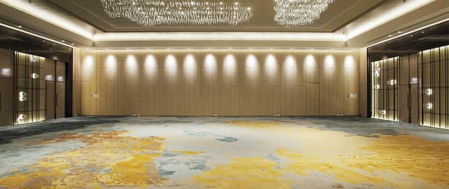 Luxury Tangla Hotel Brussels ballroom with crystal chandeliers for upscale wedding event planning.