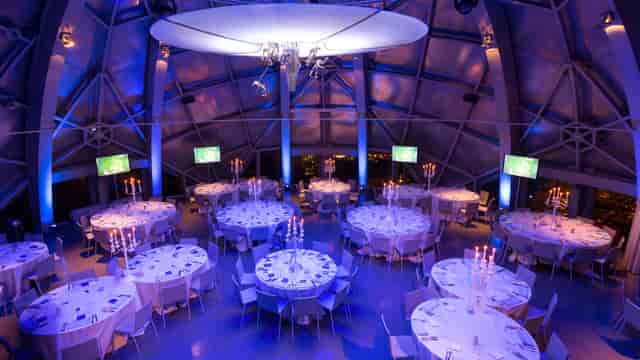 Atomium lateral sphere formal dinner with elegant architectural lighting and clean table settings.