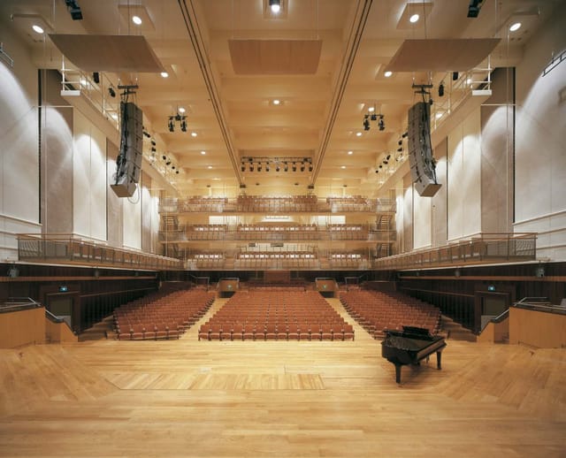 Flagey concert hall with tiered balcony seating for professional events and acoustic performances.